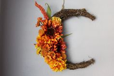 the letter c is made out of twigs and flowers