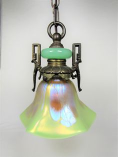 an old fashioned light hanging from a chain