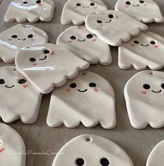 white ghost cookies with black eyes and noses