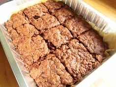 a pan filled with brownies sitting on top of a wooden table