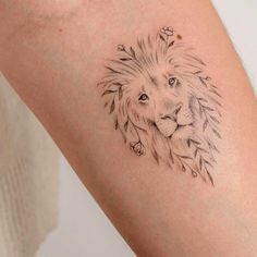 a small lion tattoo on the arm