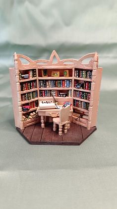 a doll house with a book shelf and desk