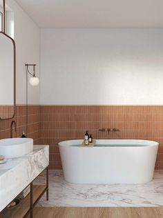 a bath tub sitting next to a sink in a bathroom