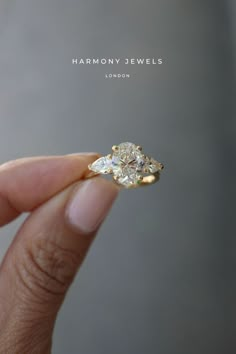 someone is holding an engagement ring in their hand with the words harmony jewels on it