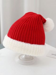 a red and white hat sitting on top of a table