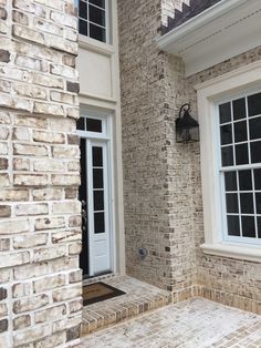 a brick building with two white doors and windows