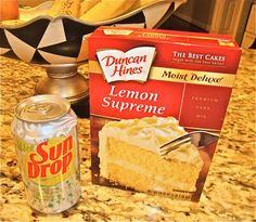 a can of lemon supreme next to a box of cake mix on a kitchen counter