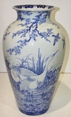 a blue and white vase sitting on top of a table