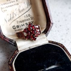 This elegant antique style gold and garnet ring would make a wonderful gift for that special someone. Set in 9 ct solid rosey yellow gold featuring 13 deep red natural garnets in a flower design. Fully British Hallmarked. INTERNATIONAL BUYERS - please read the shipping information below. Follow us on Instagram for all our latest pieces and first Dibs! They don't all make it to our Etsy store: https://www.instagram.com/mooreperfectpieces/ Fully British Hallmarked - 375 hallmark,  denoting solid 9 Victorian Rose Gold Ruby Ring, Antique Ruby Rings As Gift, Antique Garnet Jewelry For Anniversary, Victorian Cluster Ring With Rose Cut Diamonds For Gift, Vintage Garnet Birthstone Rings, Victorian Rose Cut Diamond Cluster Ring Gift, Gold Garnet Cluster Ring As Gift, Vintage Birthstone Ring With Rose Cut Diamonds, Vintage Garnet Ring As Gift