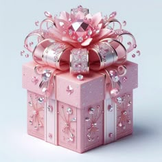 a pink gift box decorated with jewels and bows