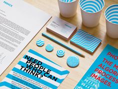 the need people think poster is displayed on a table next to some cups and papers