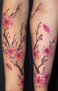 the legs are covered in tattoos with flowers on them