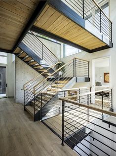 an open floor plan with stairs and railings