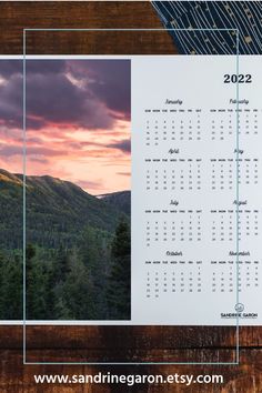 a calendar with mountains in the background