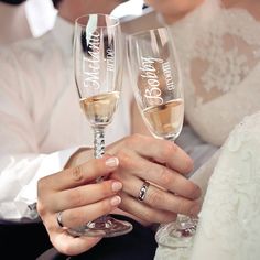 the bride and groom are holding champagne flutes