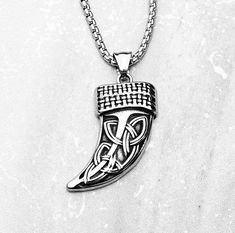 《《  SYMBOLIC COLLECTION  》》 THE DETAILS The "CELTIC KNOT HORN" Necklace is designed with an exquisitely detailed Silver Stainless Steel Celtic Horn Tusk Pendant, with intricately engraved Celtic Knots down the front! Hung from a Silver Stainless Steel Box Chain available in your choice of length! THE SYMBOL CELTIC KNOT HORN/TUSK: The Tusk is a symbol of "MENTAL STRENGTH, WISE CHARACTER, & PROTECTION", combined with the Celtic Knots symbol of "Eternity", whether this means loyalty, faith, friendship or love, this symbol depicts how life & eternity are interconnected.  Together is a symbol of Eternal Strength, Wisdom, and Protection of both yourself and of those knotted within your life that you hold dear. View our other CELTIC KNOT HORN TUSK Pendant Necklaces here: 🔶️GOLD Stainless Steel C Wise Character, Tusk Pendant, Necklace Length Chart, Black Two Piece, Horn Necklace, Box Chain Necklace, Celtic Knots, Jewelry Care Instructions, Mental Strength