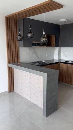 an empty kitchen with marble counter tops and wooden paneling on the back splashes