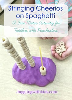 a child is playing with an object made out of dough and pretzels