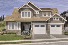 a two story house with three garages on the front and one above the garage