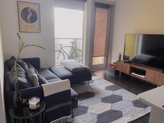 a living room filled with furniture and a flat screen tv