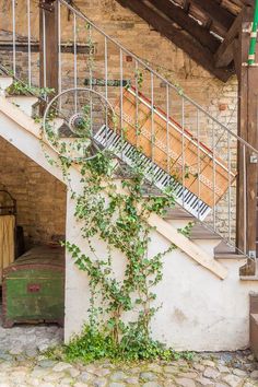 an old piano sitting on top of a set of stairs