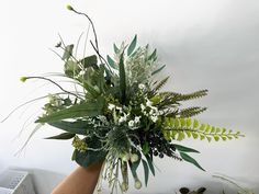 a vase filled with lots of green and white flowers