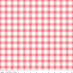 a pink and white checkered fabric with a ruler in front of the bottom half