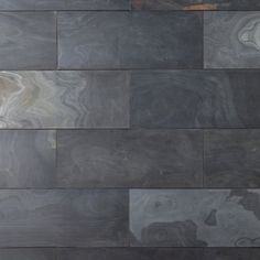 a black and white tile wall that has been made from different types of marbles