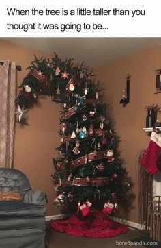 a small christmas tree with ornaments on it in a living room next to a chair