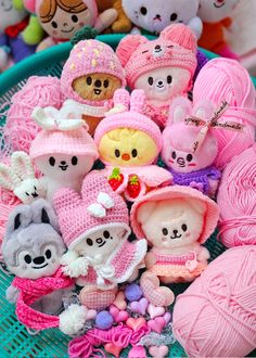 a basket filled with lots of different types of knitted animals and balls of yarn