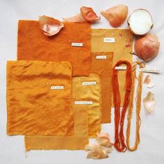 several different types of food are laid out on a white tablecloth, including garlic and onions