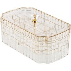 a clear glass box with a gold handle on it's lid and a small knob in the middle