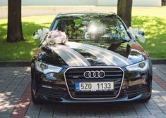 an audi car decorated with flowers and ribbons