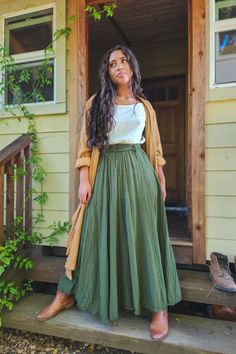 We love The Athena for her strength and sweet femininity. Hike this skirt up with your boots and run up a hill in the Summer sun. Her lux bow communicates abundance ~ because behind a bow is a delight to be discovered. This boho skirt is made of 100% lightweight, breathable woven cotton. Our eco-friendly gauze clothing is all handmade, hand-dyed. #skirt #maxiskirt #longskirt Feminine Clothing Winter, Maxi Skirt Boho Outfit, Womens Bohemian Style, Earthy Boho Fashion, Boho Modern Clothes, Maxi Skirt Tank Top Outfit, Bohemian Feminine Style, Fall Outfits Women Boho, Winter Boho Skirt Outfit