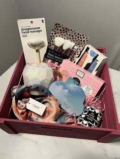 a pink box filled with assorted items on top of a table