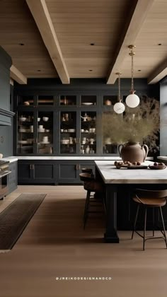 a large kitchen with black cabinets and white counter tops