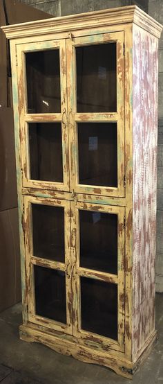 an old wooden cabinet with glass doors