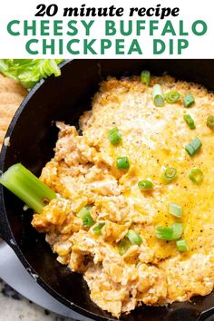 cheesy buffalo chicken dip in a cast iron skillet with celery on the side