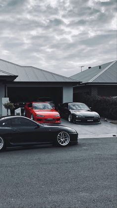 three cars parked in front of a house