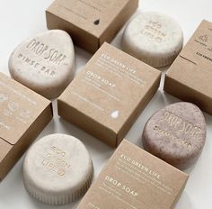 six soaps are sitting on top of each other, with different types of packaging