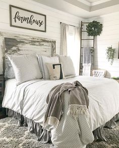 a white bed sitting in a bedroom next to a wooden headboard and foot board