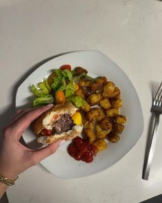 a white plate topped with food next to a fork and knife