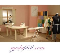 a sewing studio with two tables and ironing board