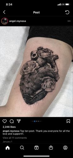 a black and white photo of a heart with roses on it's side thigh