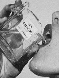 a person holding a bottle of chanel perfume in their left hand, with the label on it