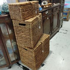 three wicker baskets stacked on top of each other in front of a dresser and mirror