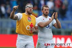 two rugby players applauding each other on the field