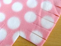 the pink and white polka dot fabric has been cut into pieces to make a heart shape