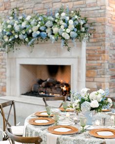 the table is set with plates and place settings