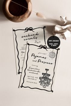 two black and white menus on top of a table